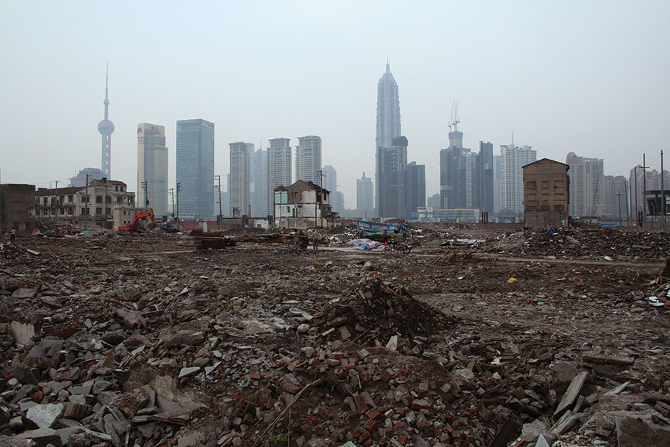 shanghai skyline behind a demolished neighborhood